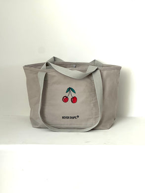 A large basalt-like gray fashion tote bag with a red cherry pattern,  DTF printing